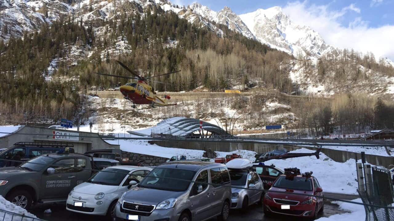 A helicopter carries survivors of an avalanche in northern Italy