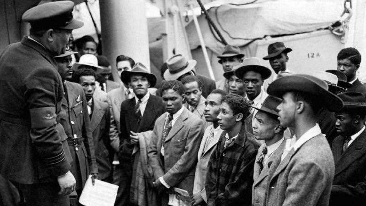 Jamaican immigrants welcomed by RAF officials from the Colonial Office after the ex-troopship HMT 'Empire Windrush' landed them at Tilbury.