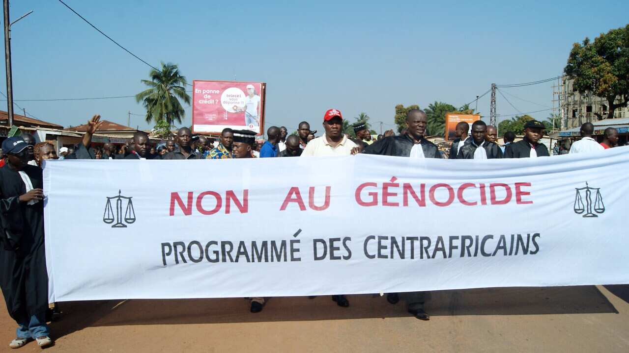 Protesters hold a banner reading 'No To The Scheduled Genocide of Centrafricans' after the murder in November of the director of the Central African Judiciary services getty.jpg