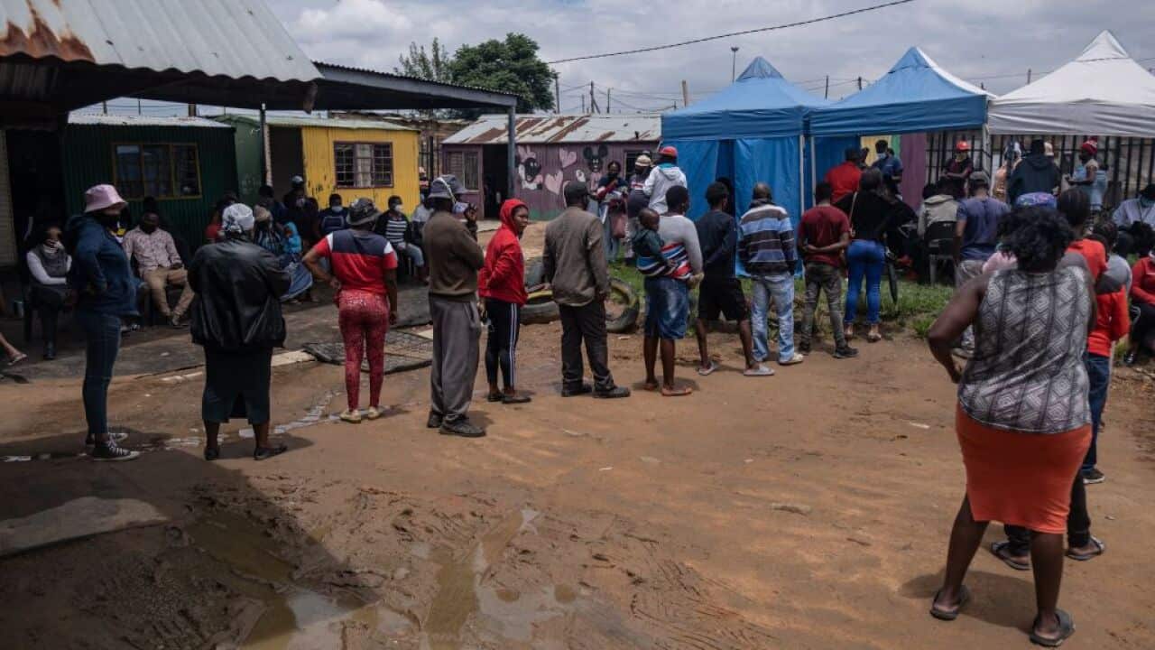 People queue at the Kya Sands informal settlement to be vaccinated against COVID-19 by the Witkoppen clinic in Johannesburg on 8 December 2021.