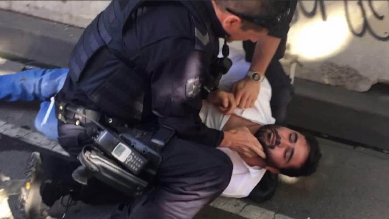 The man pinned down by Victoria Police after the incident near Flinders St station in Melbourne on Thursday, Dec 21