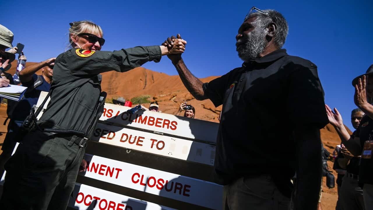 Uluru-Kata Tjuta Ranger Lynda Wright (left) and Chair of the Uluru-Kata Tjuta Council Sidney James celebrate the permanent closure of the climb. 