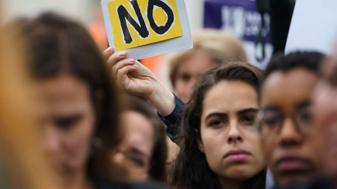 Protesters gather in front of the Supreme Court on Capitol Hill in Washington, Monday, Sept. 24, 2018.