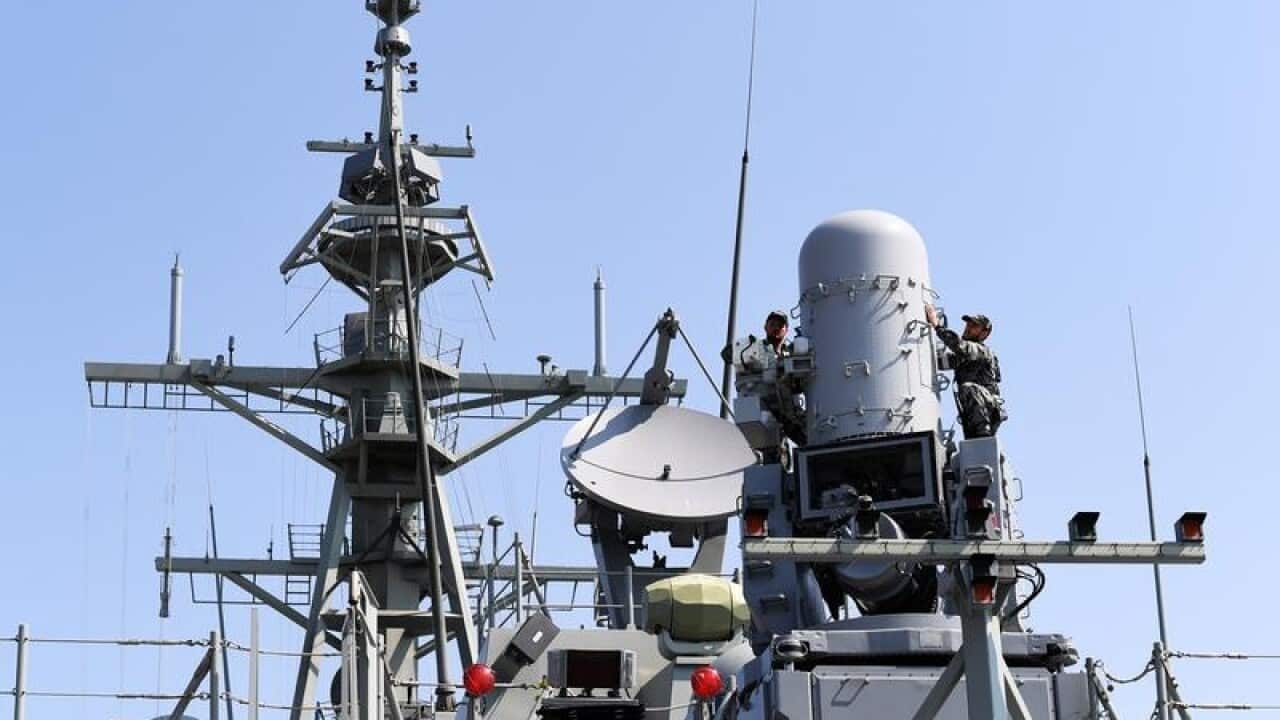 Crew of the NUSHIP Hobart work the deck