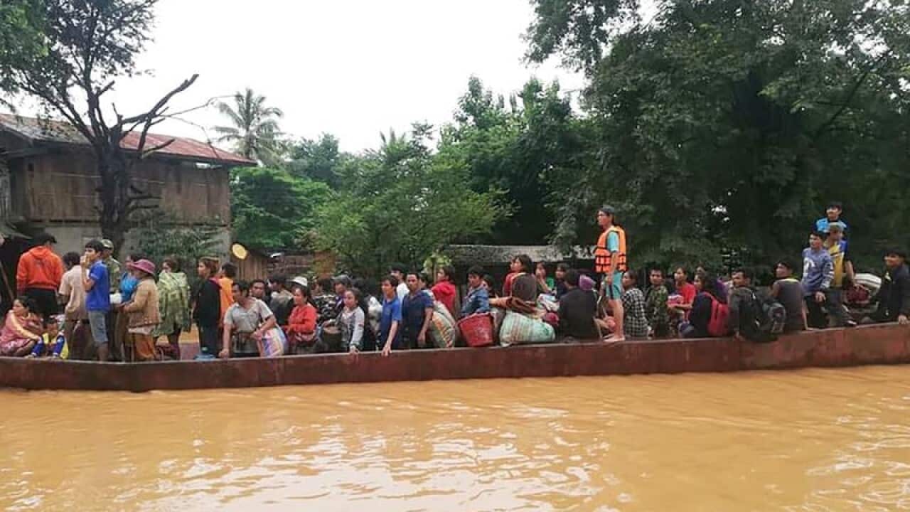 Lao villagers escape on a boat.