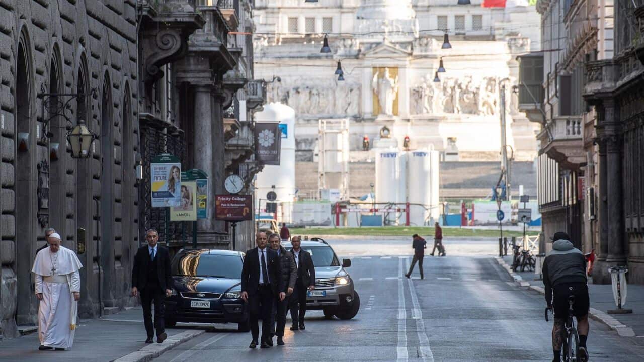 Pope Francis (L) walks to the church of San Marcello al Corso.