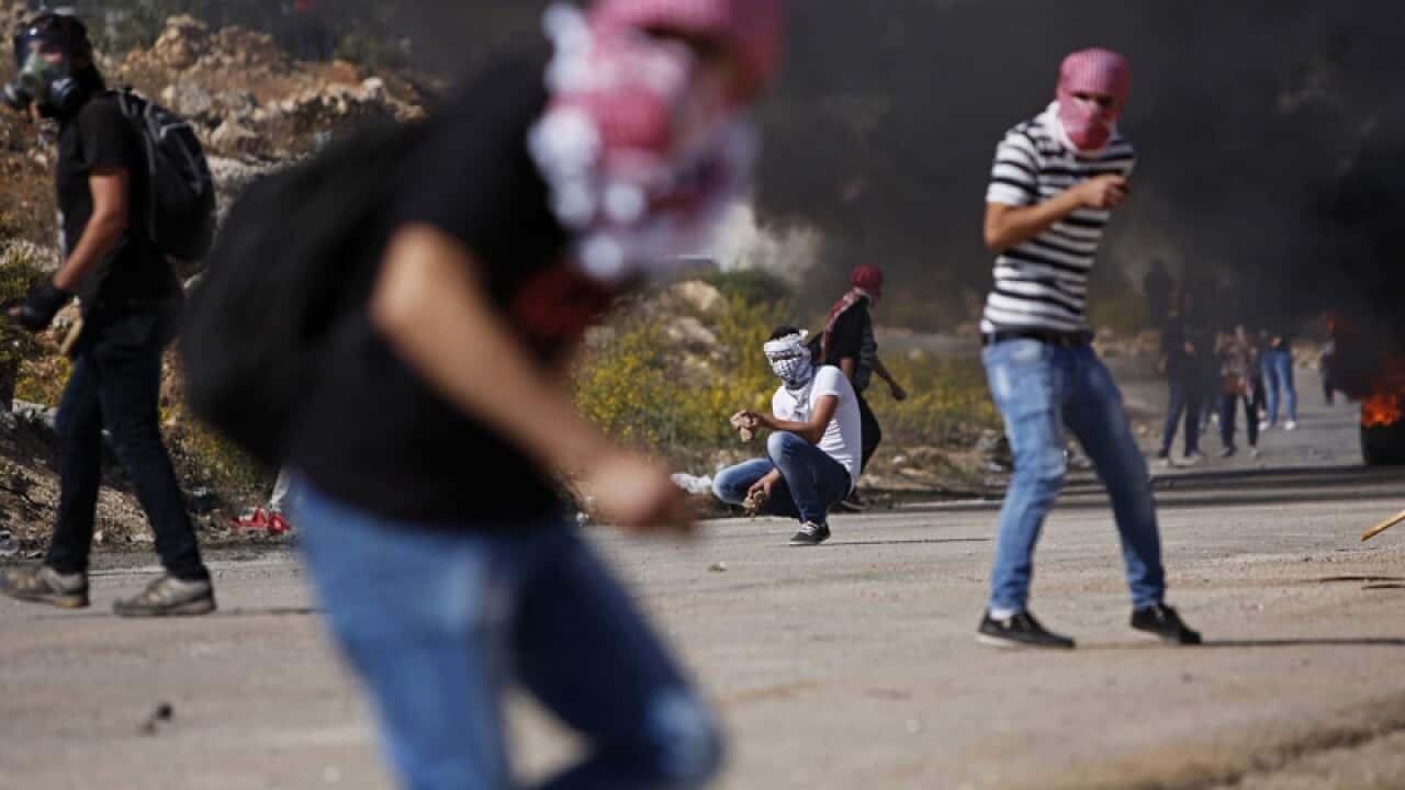 Palestinian protester hurls stones towards Israel troops