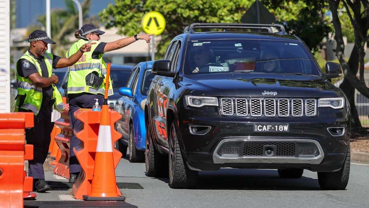 Motorists passes through a border control checkpoint at Coolangatta, Qld