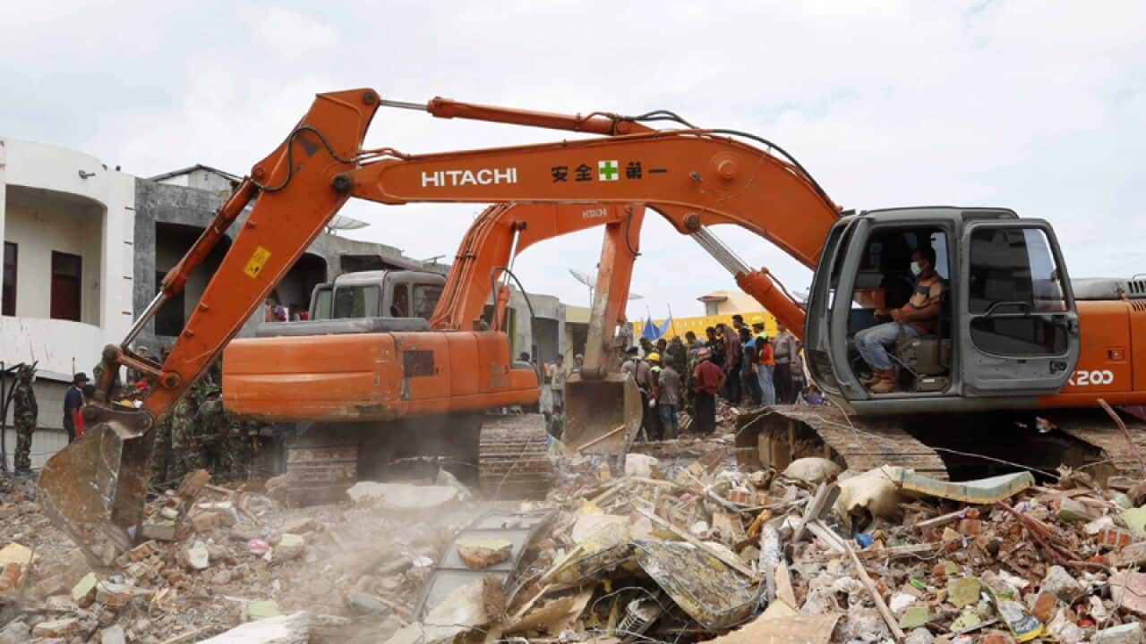 Indonesian rescue team search for victims of an earthquake