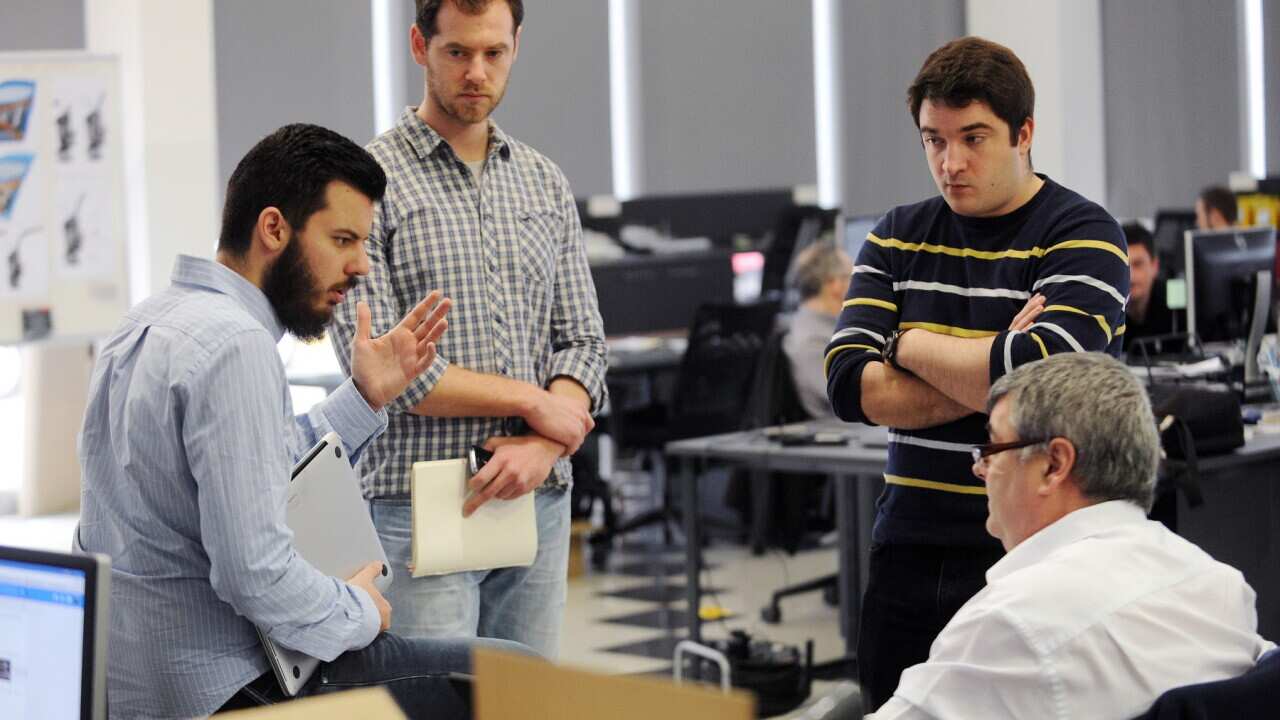 Croatian inventor of the world's first electric supercar Mate Rimac (L), 28, talks to employees at his factory in Sveta Nedelja