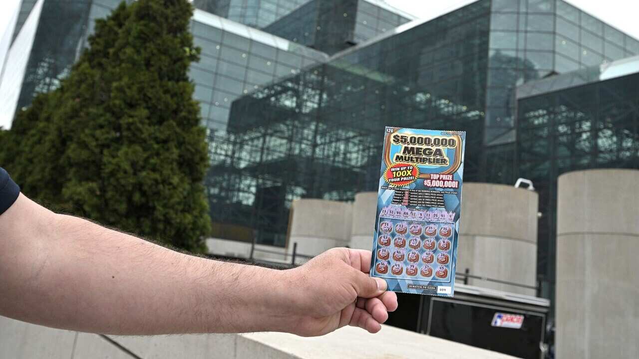 A man shows his free lottery ticket (normally $20 to buy) outside the Javits Center after getting this first COVID-19 vaccine shot, in New York, NY, May 24, 2021