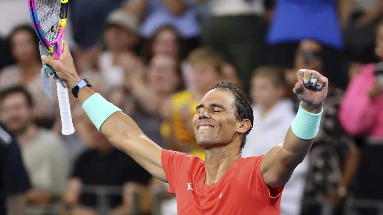 Rafael Nadal of Spain holds up his arms in a gesture of happiness.