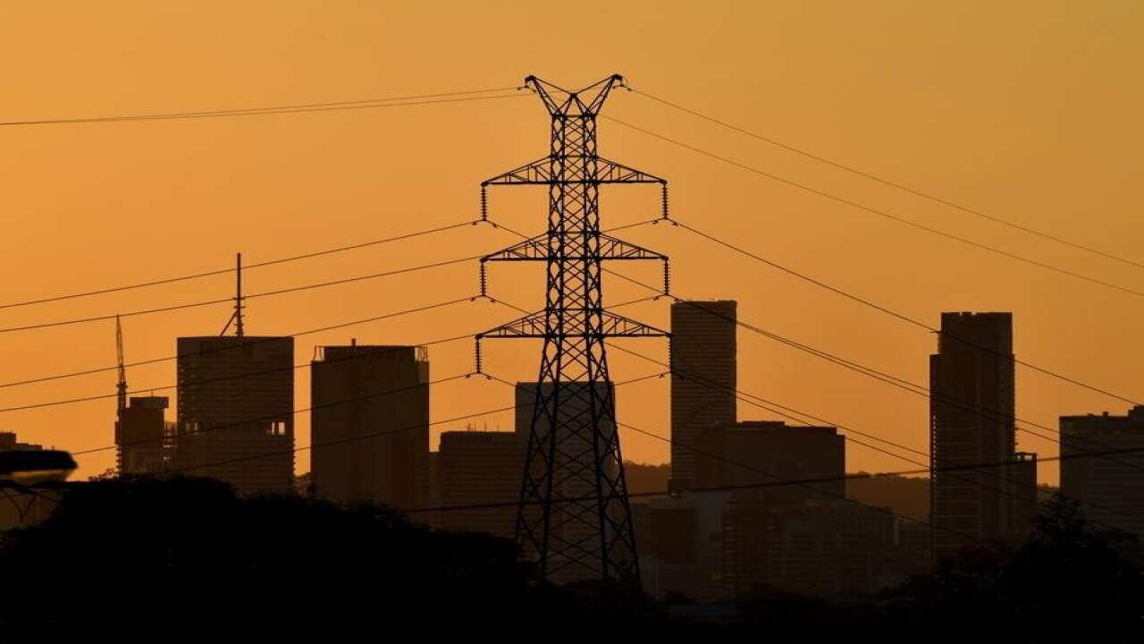 A high voltage electricity transmission tower is seen.