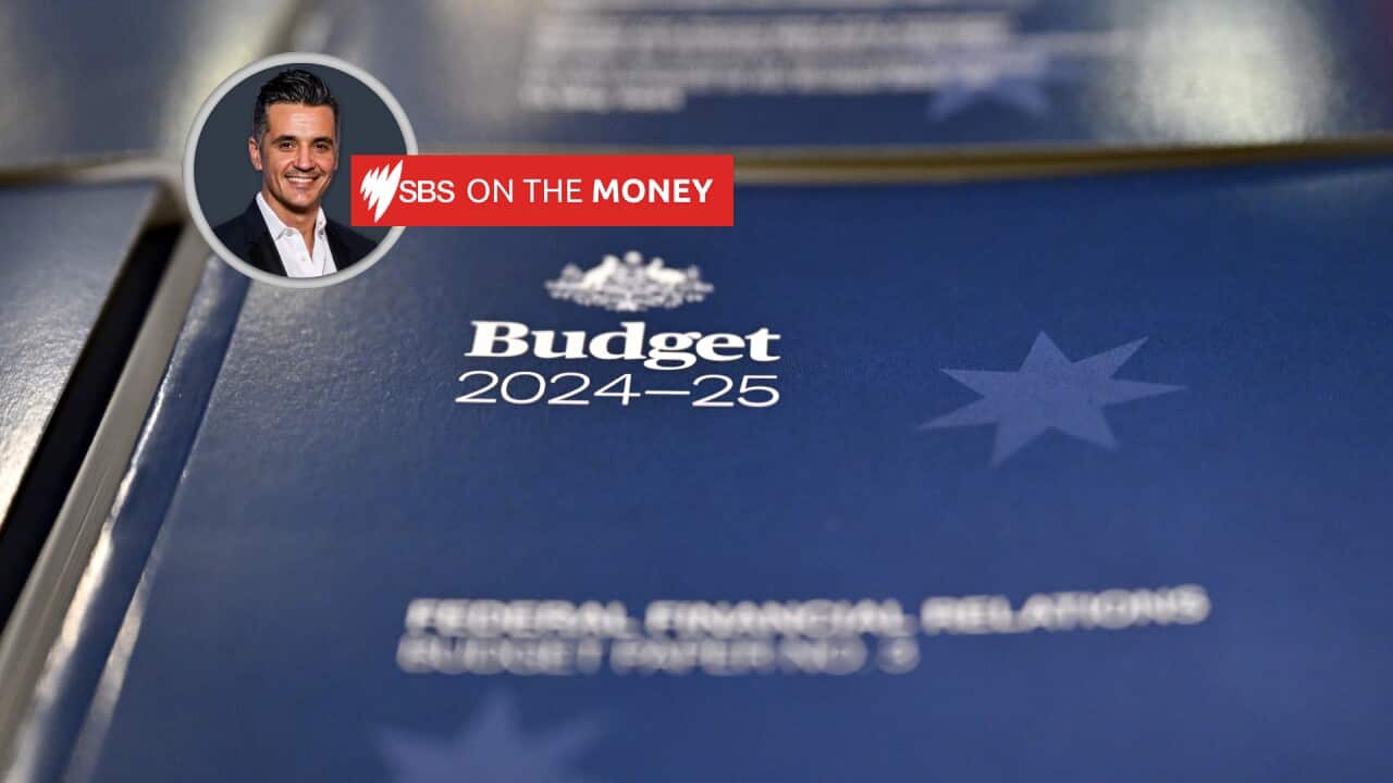 The blue cover page of the federal budget paper volume can be seen, with the budget title in focus.