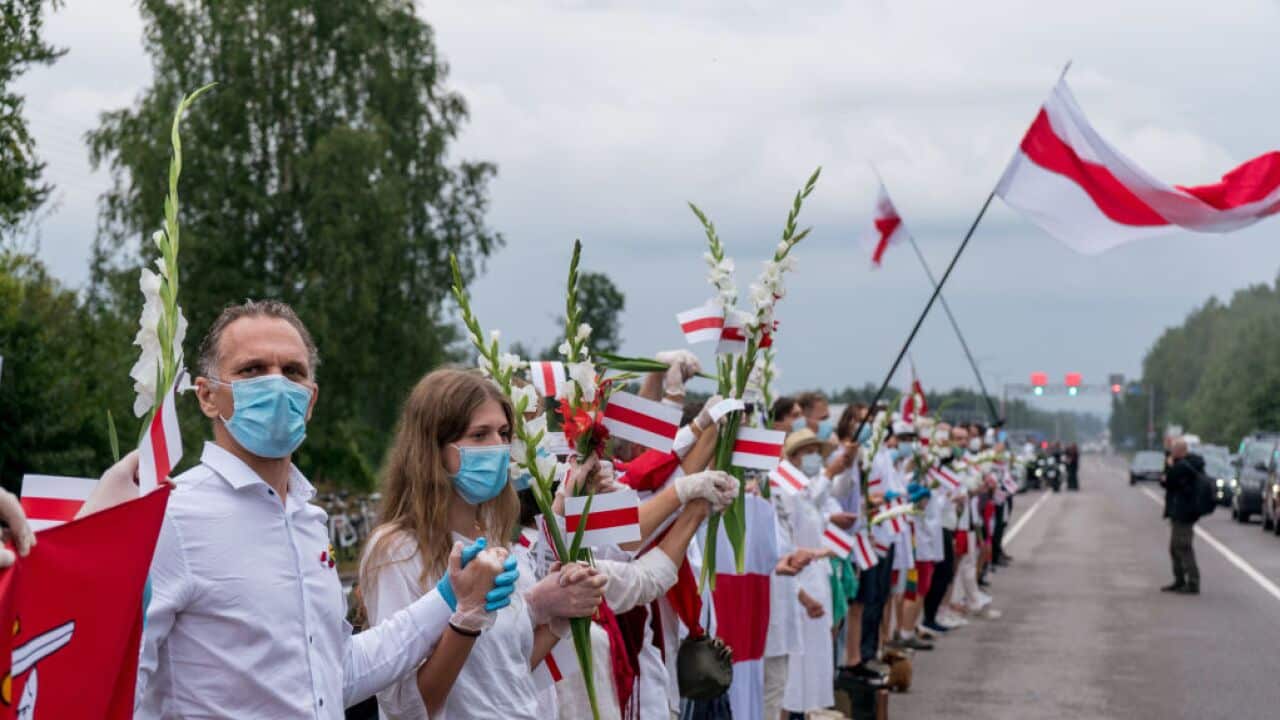 People hold hands as they participate in a human chain near Medininkai