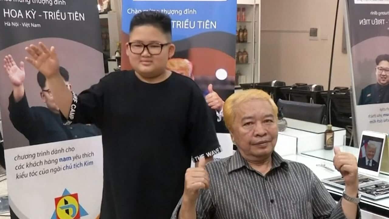 Hanoi barber providing haircuts in the style of Kim Jong Un and Donald Trump.