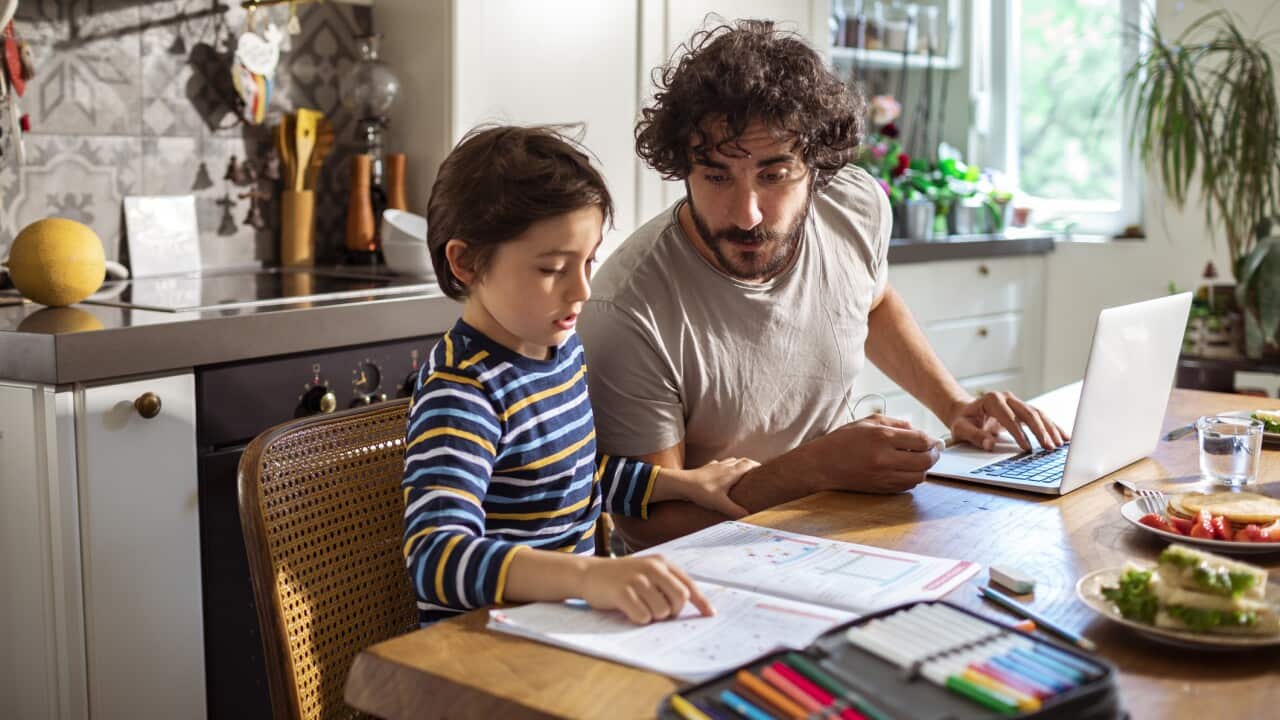 Father helping his son with schoolwork