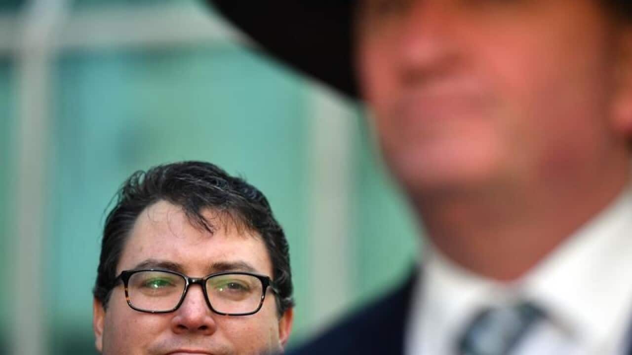 Nationals MP George Christensen behind exiting leader Barnaby Joyce.