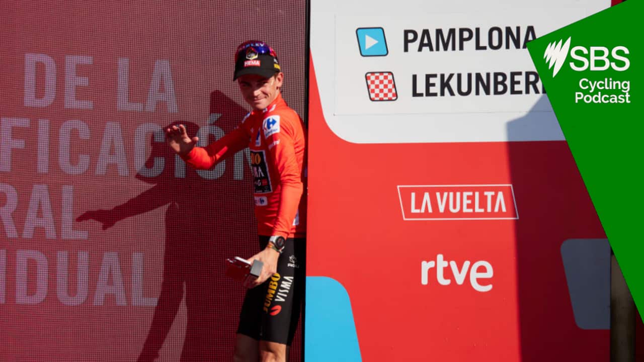 Sepp Kuss on the podium of the Vuelta receiving a red jersey