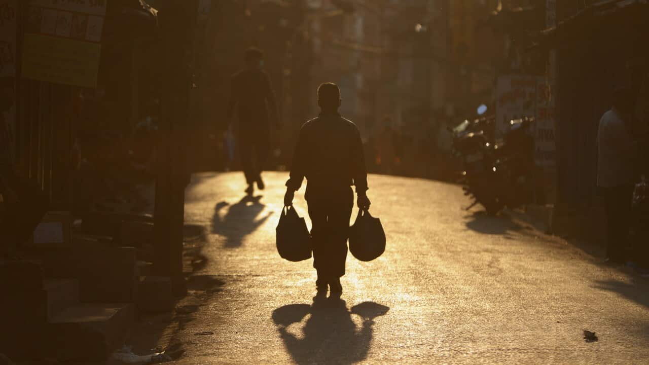 A Nepalese man walks back home from a market during lockdown in Kathmandu, Nepal, Thursday, May 14, 2020. The Nationwide lockdown began March 24 to control the spread of the new coronavirus and was extended till May 18. (AP Photo/Niranjan Shrestha)