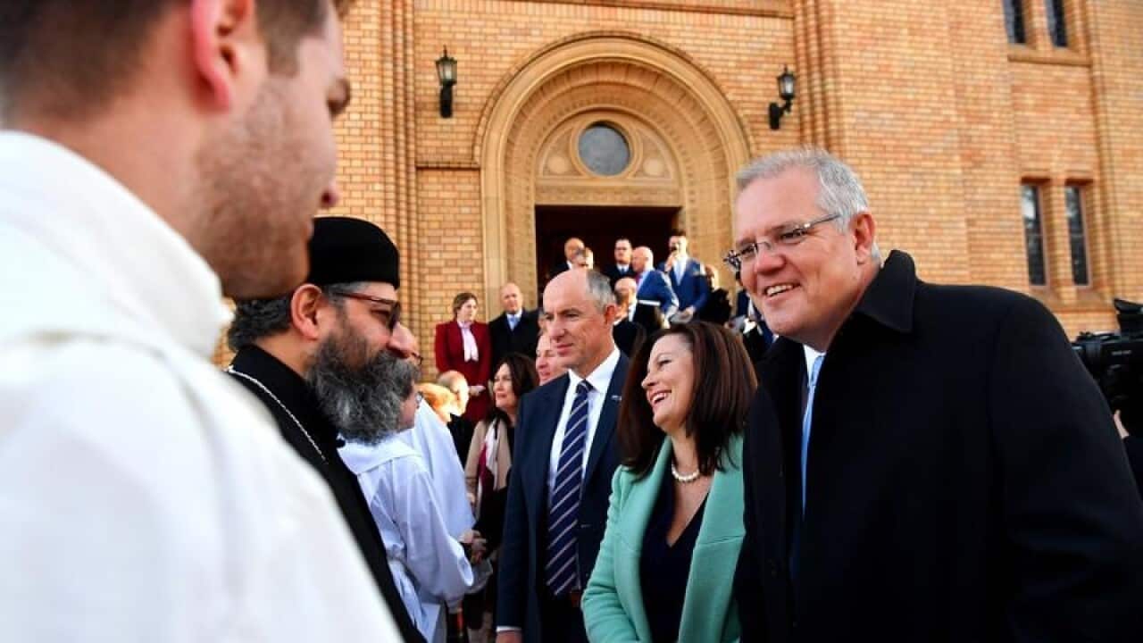 PM Scott Morrison (R) and wife Jenny meet the clergy.