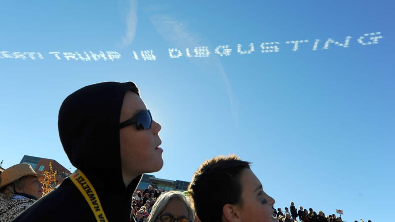 An anti-Donald Trump message is seen over the Rose Parade