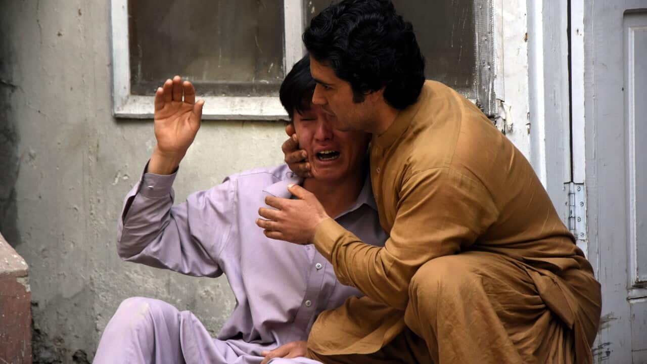 Relatives of the victims of bomb blast react outside a mortuary in Quetta, Pakistan.