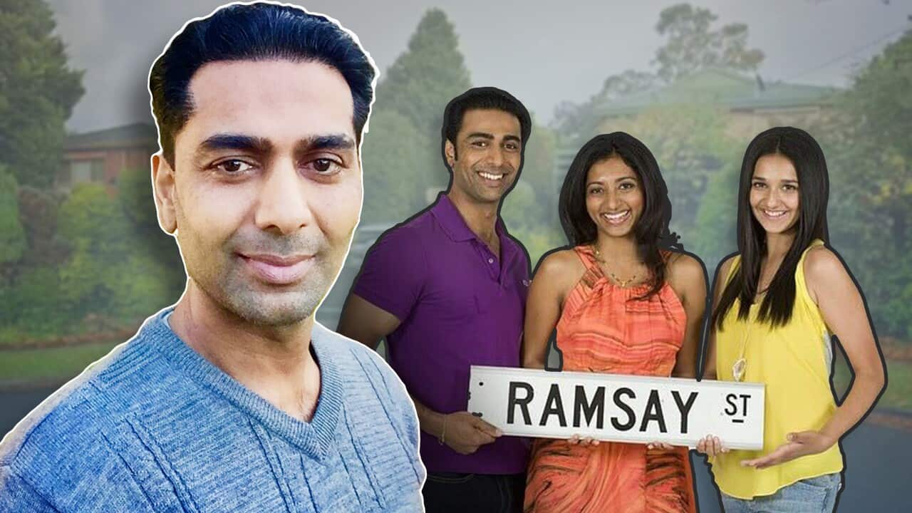 A man in the foreground and three people holding a Ramsay St sign.