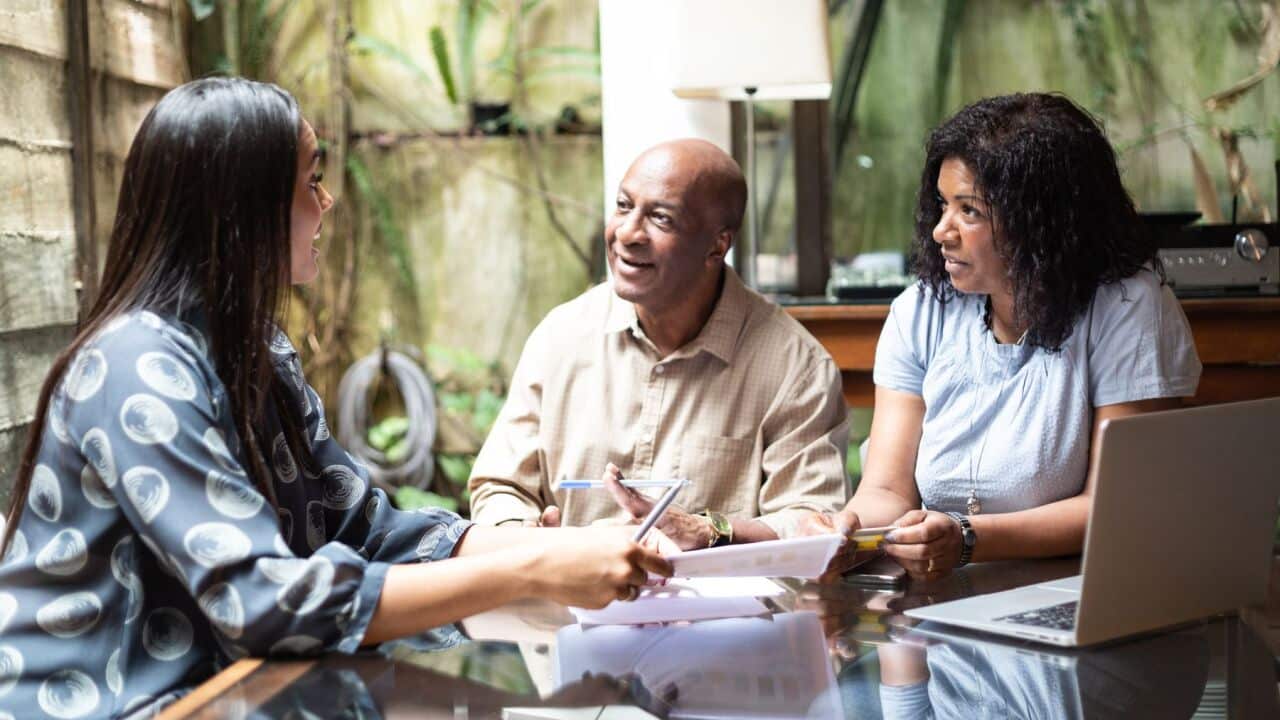 A dad and mum talking to their daughter