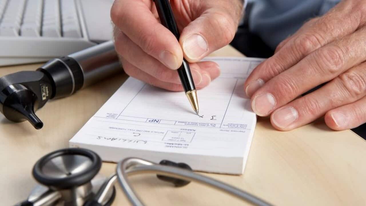 General practice doctor writing prescription