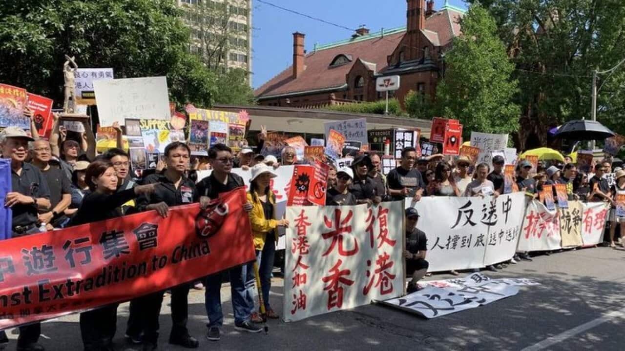 Hundreds of protesters gathered outside the Hong Kong Economic and Trade Office in Toronto on Sunday afternoon, holding large posters and chanting in unison: “Free Hong Kong!”