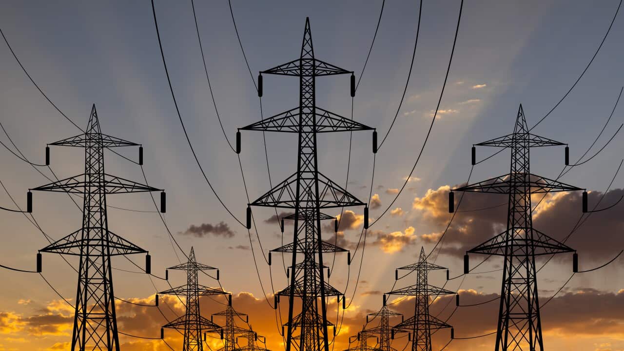 High voltage towers at sunset background. Power lines against the sky