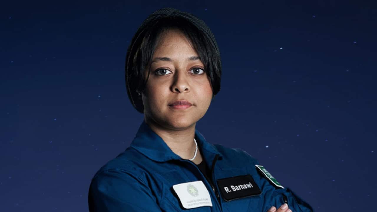 An astronaut poses for a photo.