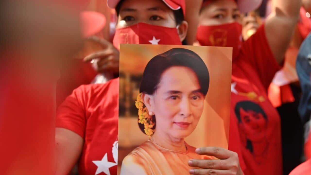 A Myanmar migrant holds up an image of Aung San Suu Kyi during a demonstration outside the Myanmar embassy in Bangkok on 1 February 2021.