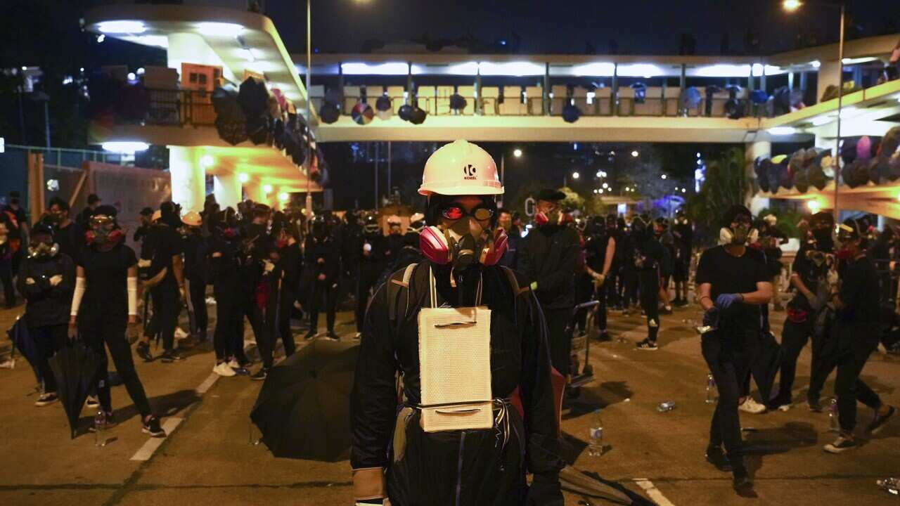 Pro-democracy protesters gather outside the campus of the Hong Kong Baptist University in Hong Kong, Wednesday, Nov. 13, 2019.