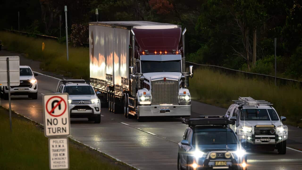 Photo : SBS A large semi-trailer truck travels along a multi-lane road alongside several passenger and utility vehicles