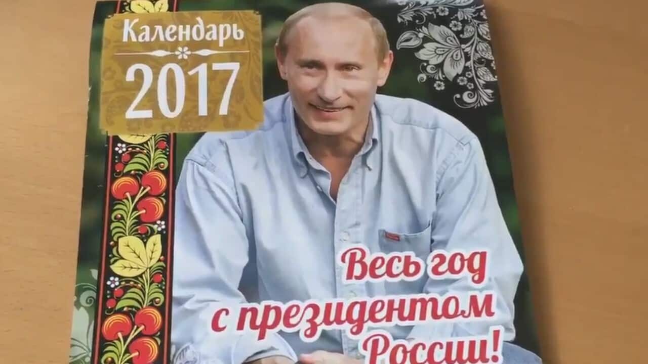 Putin appearing on the front of a calendar in Russia