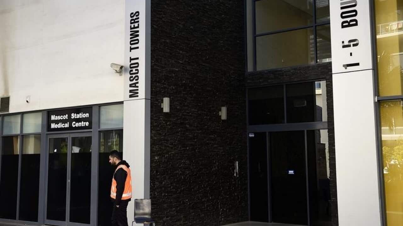 A security guard at the entrance of the Mascot Towers in Sydney