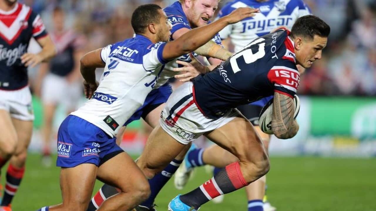 Sonny Bill Williams beats Moses Mybe to score for the Roosters.