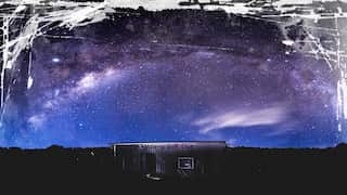 The night sky is a vibrant array of purple and blue in Maleny, Brisbane. The Milky Way visible to the human eye.