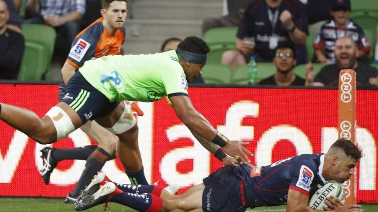 Tom English of the Rebels scores a try during Round 3.
