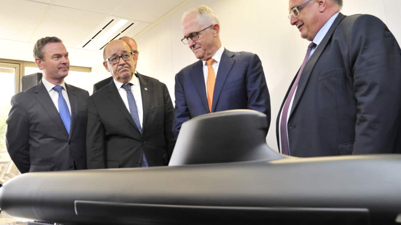 Australian and French representatives with a model DCNS submarine