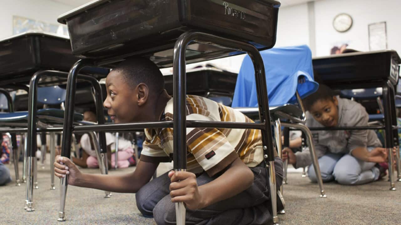 A class rehearses the earthquake drill procedure in Paducah