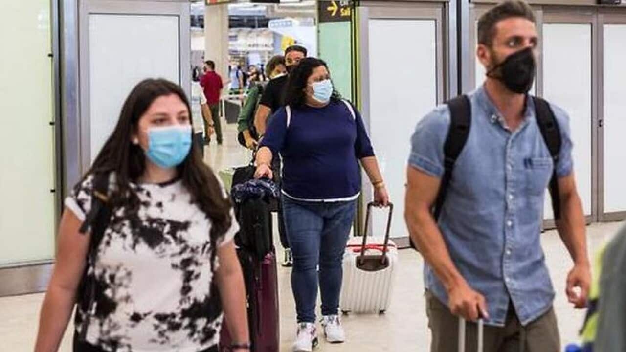 Passengers walking though Arrivals terminal