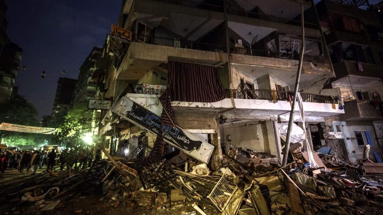 People inspect the damaged building that was rocked by an explosion, in Giza, Egypt, 27 December 2015. According to reports, a woman was killed and dozen were injured in an explosion at a residential building in Faisal neighborhood of Giza. (EPA)