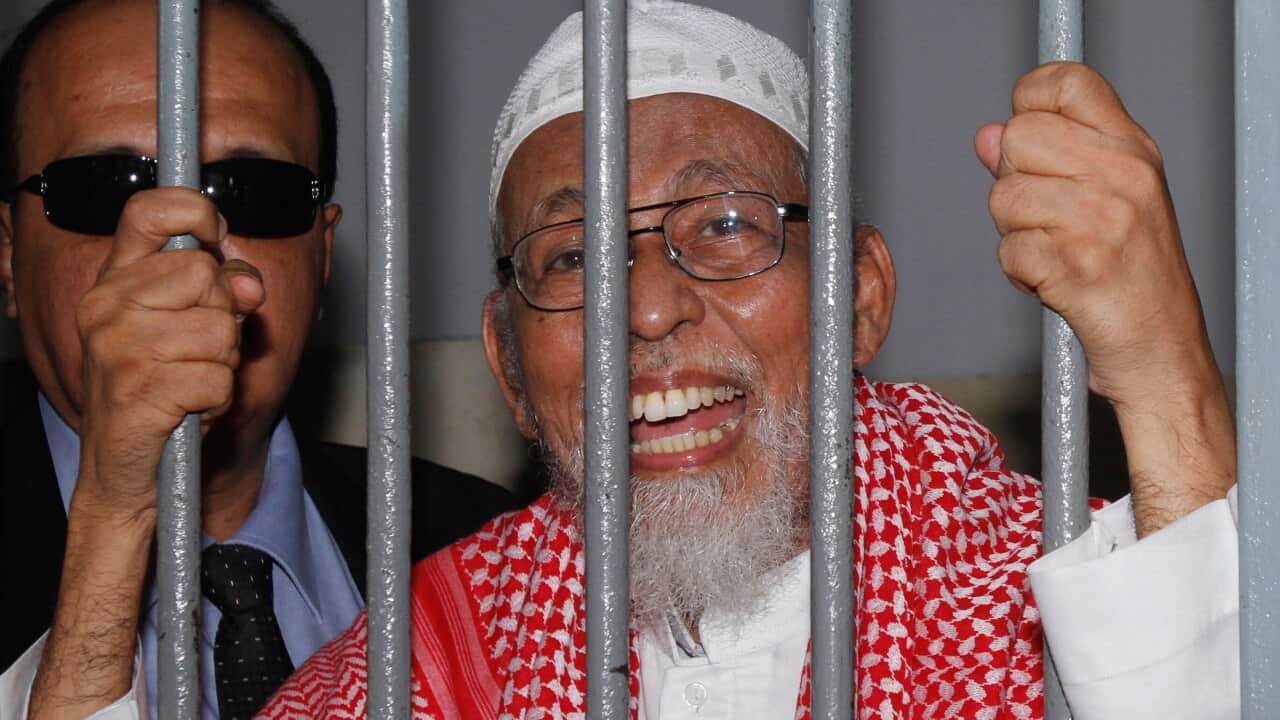 Radical Muslim cleric Abu Bakar Bashir behind bars of a holding cell before trial at a district court in Jakarta, Indonesia, Thursday, Feb. 24, 2011.