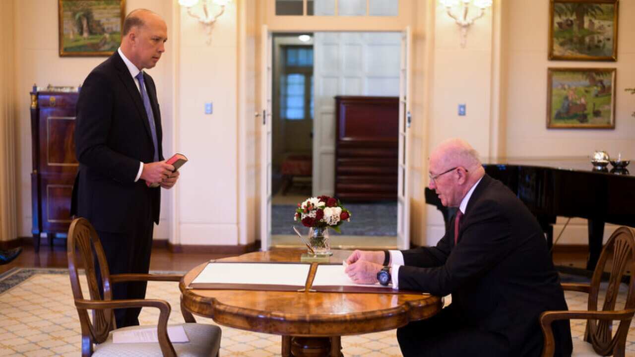 Liberal MP Peter Dutton (left) is sworn in as Home Affairs Minister, again