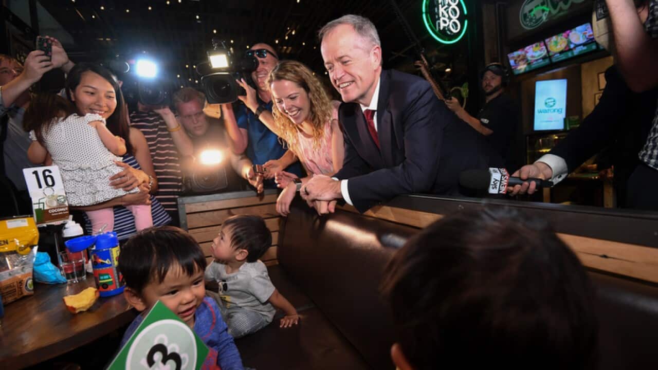 Opposition Leader Bill Shorten and Labor candidate for Boothby Nadia Clancy speak to a family at a shopping centre in Adelaide