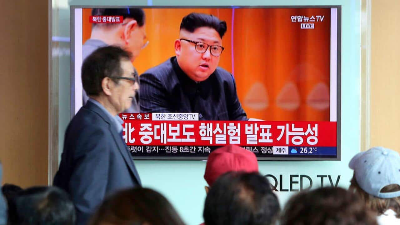 People watch a TV news program showing North Korean leader Kim Jong Un at the Seoul Railway Station in Seoul