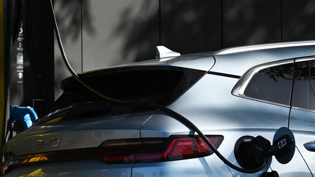 An silver electric vehicle being charged.